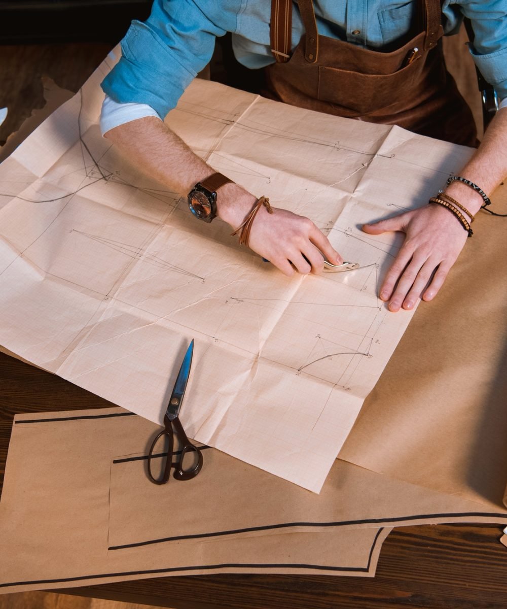 cropped-shot-of-male-fashion-designer-in-apron-making-sewing-patterns-at-workplace.jpg